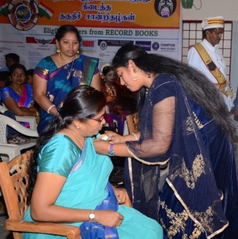 The vice-president of 'Cholan' book of world records Mrs N, Arthiga with Hon, Sivagangai district collector Mrs.G.Latha